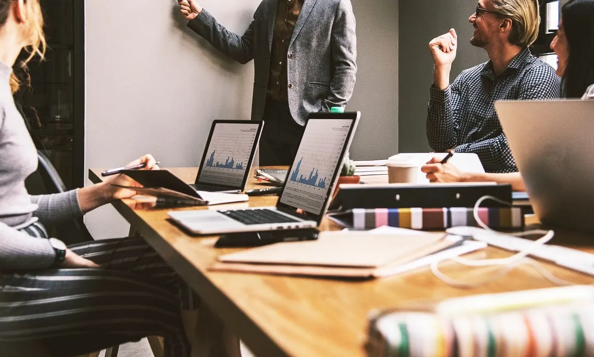 Image of people around a desk