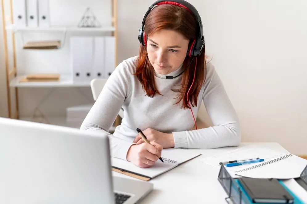 image of a woman working at a desk